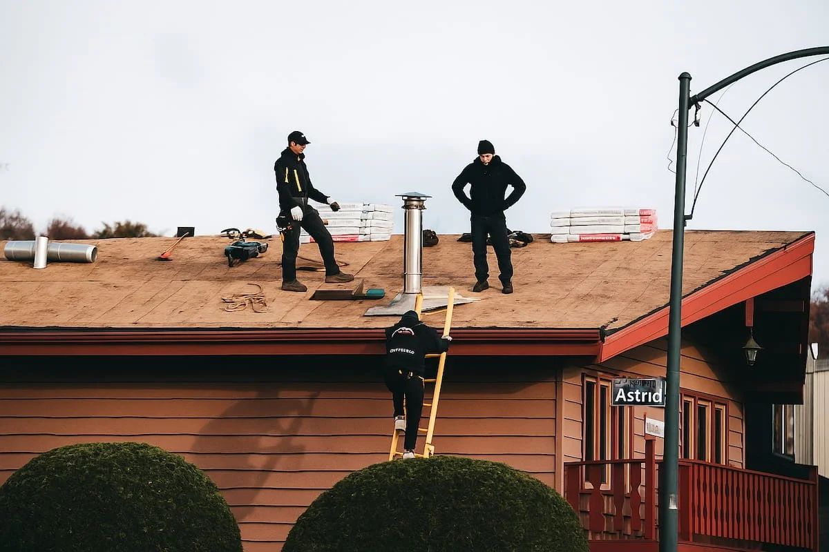 Roofing team repairing a home roof.