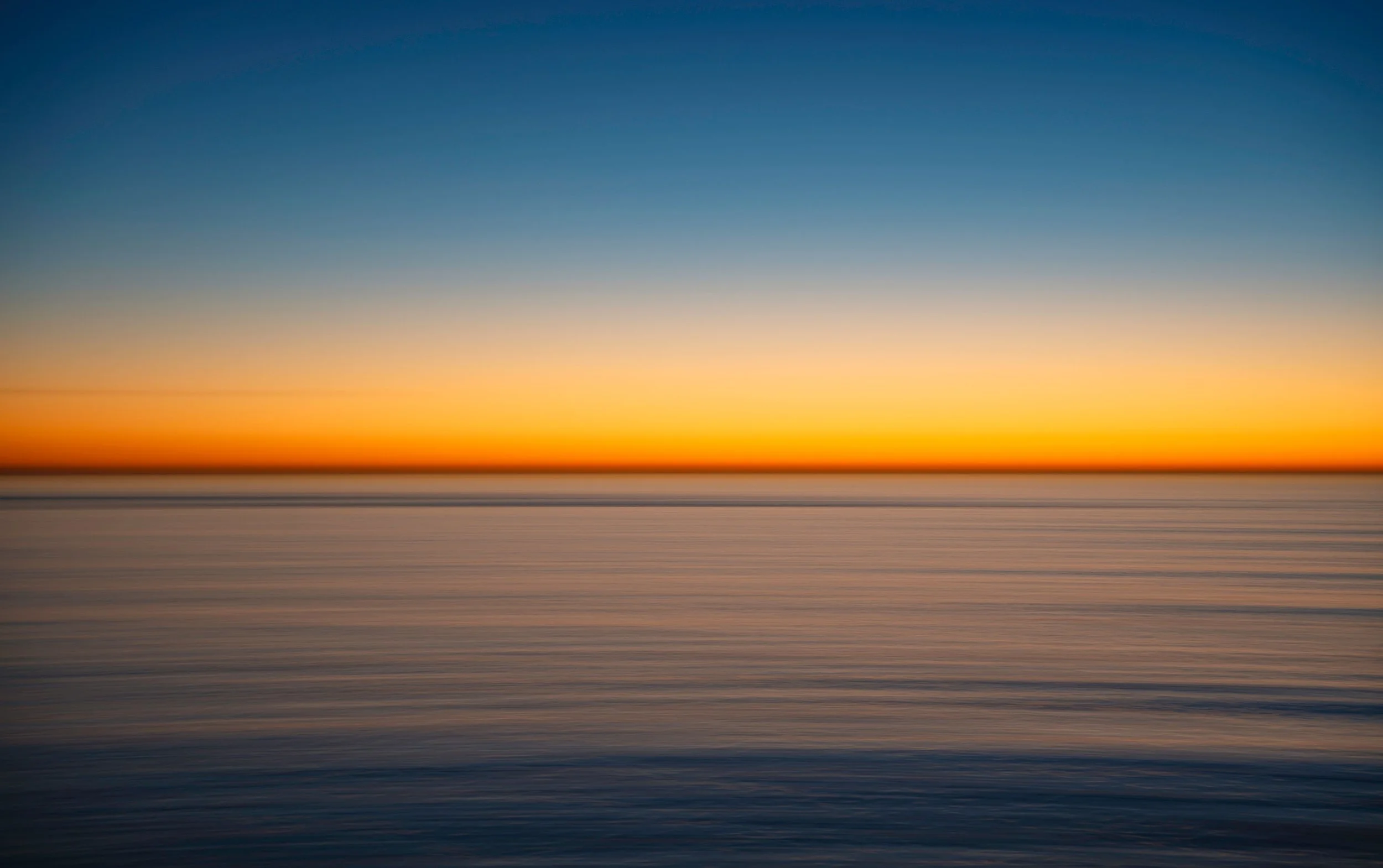 Soft horizon line with sky meeting land in a minimal landscape