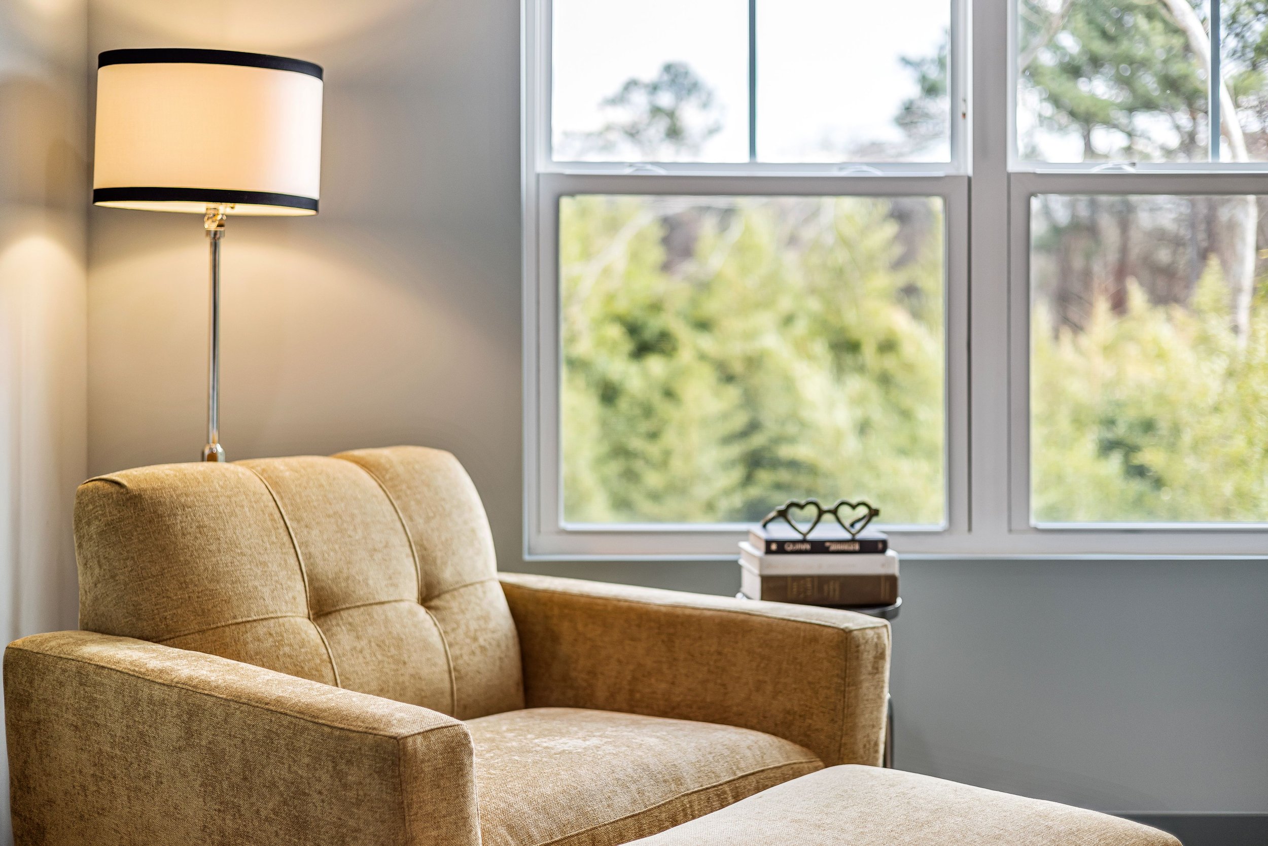 A warm, inviting therapy chair beside a window with soft natural light -- Seek the Sun Psychotherapy, virtual therapy available throughout Texas.