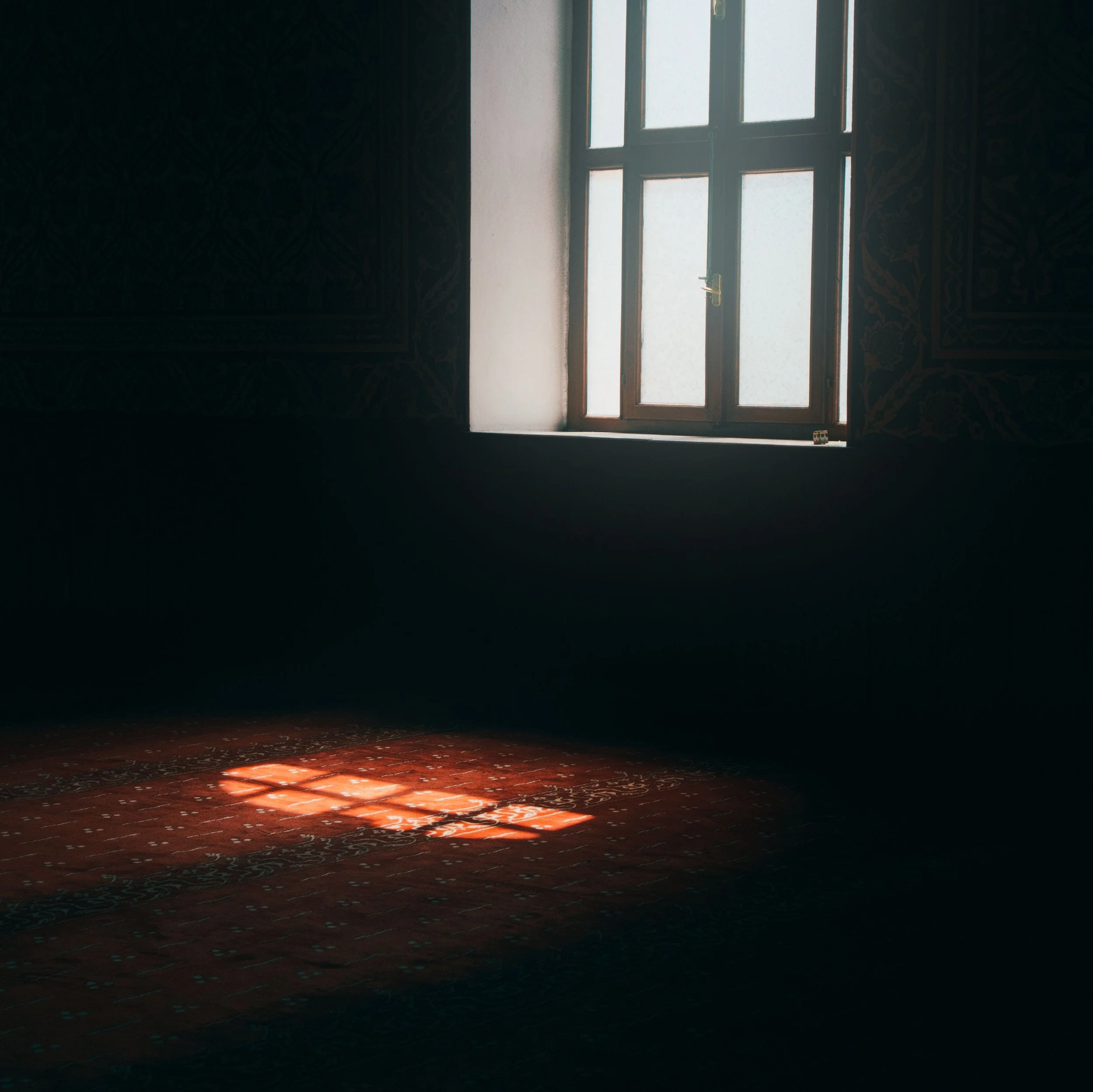 Sunlight filters through a window into a quiet room, reflecting themes of awareness, insight, and understanding patterns shaped by early family experiences.