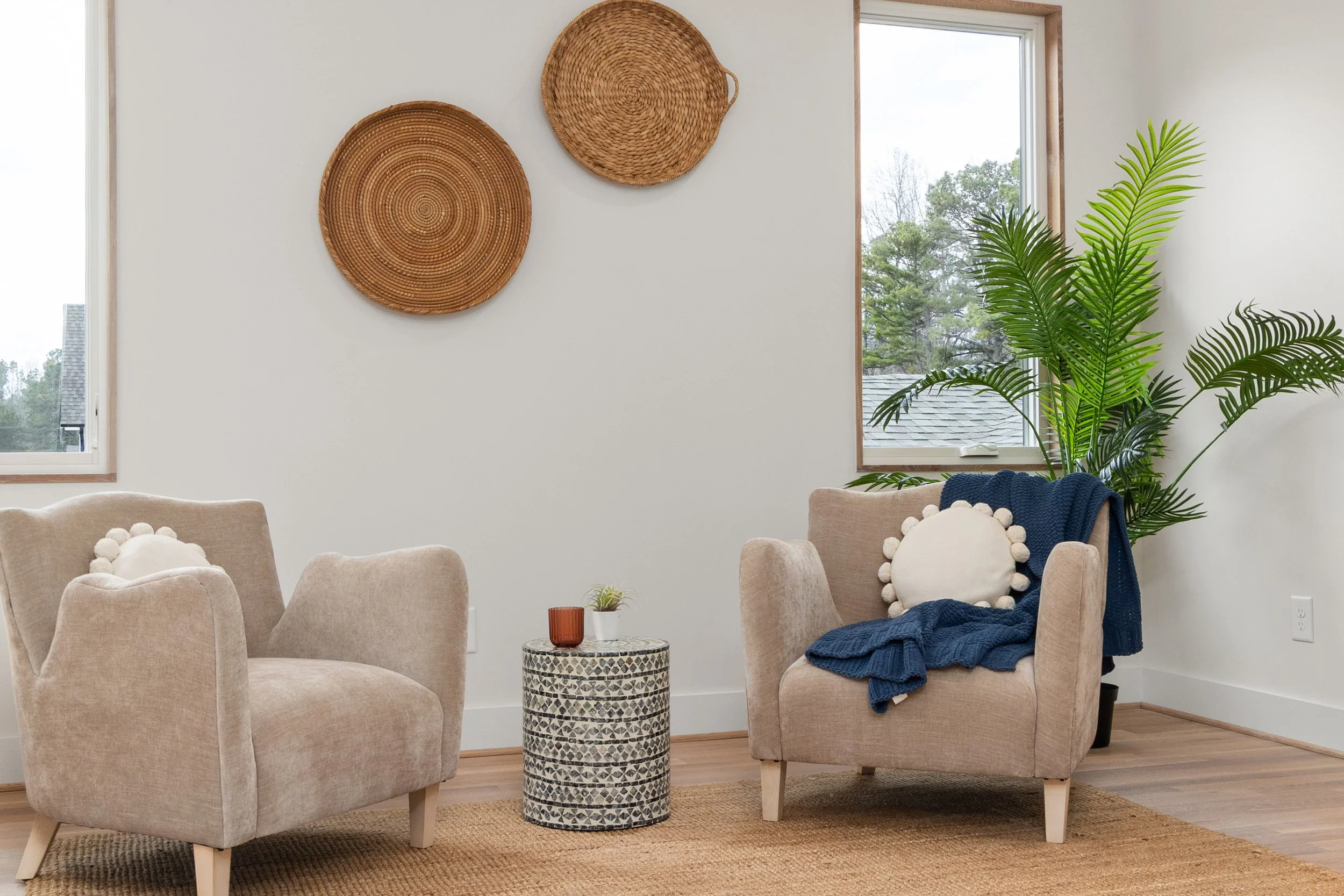 Two cozy armchairs in a warm therapy office at Seek the Sun Psychotherapy in Austin Texas.