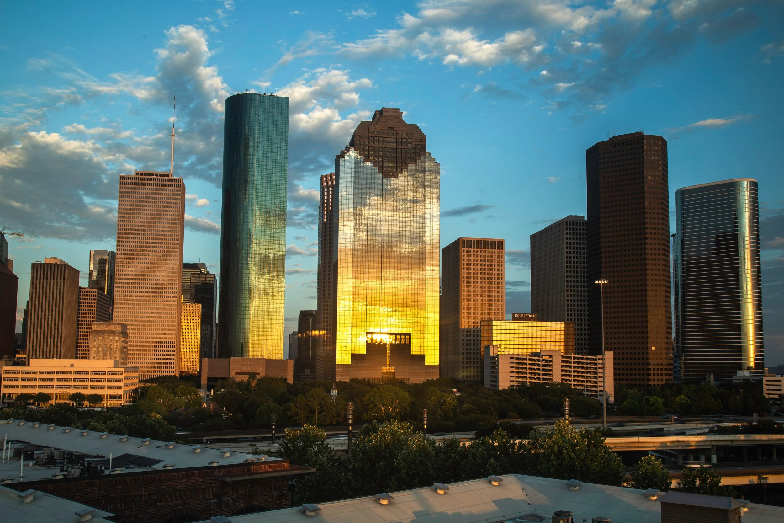Houston city skyline at sunset -- virtual therapy available to individuals and couples throughout Texas at Seek the Sun Psychotherapy.