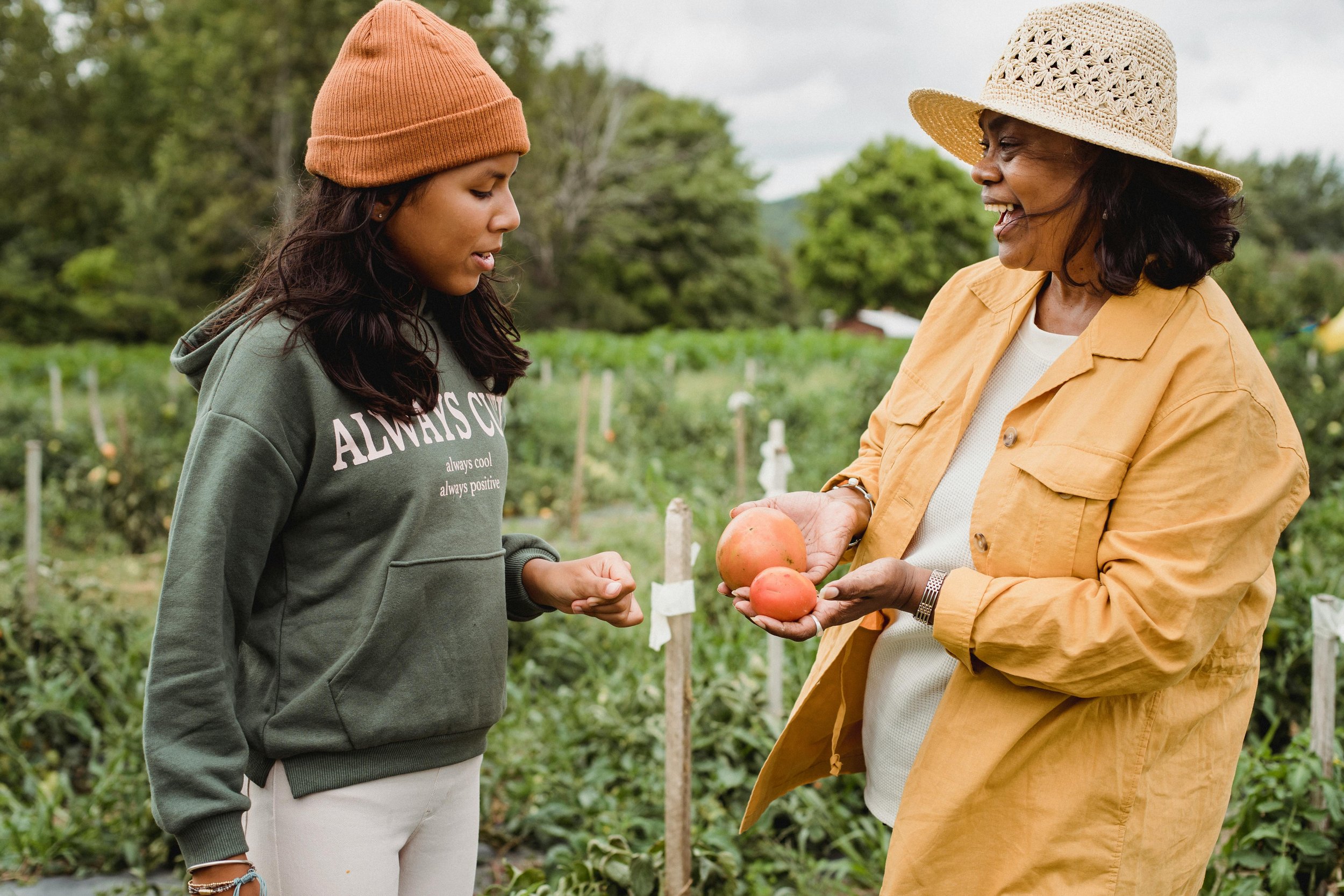 A mother and daughter working together in a garden, representing the support and collaboration that therapy can help restore between parents and teenagers navigating difficult family dynamics