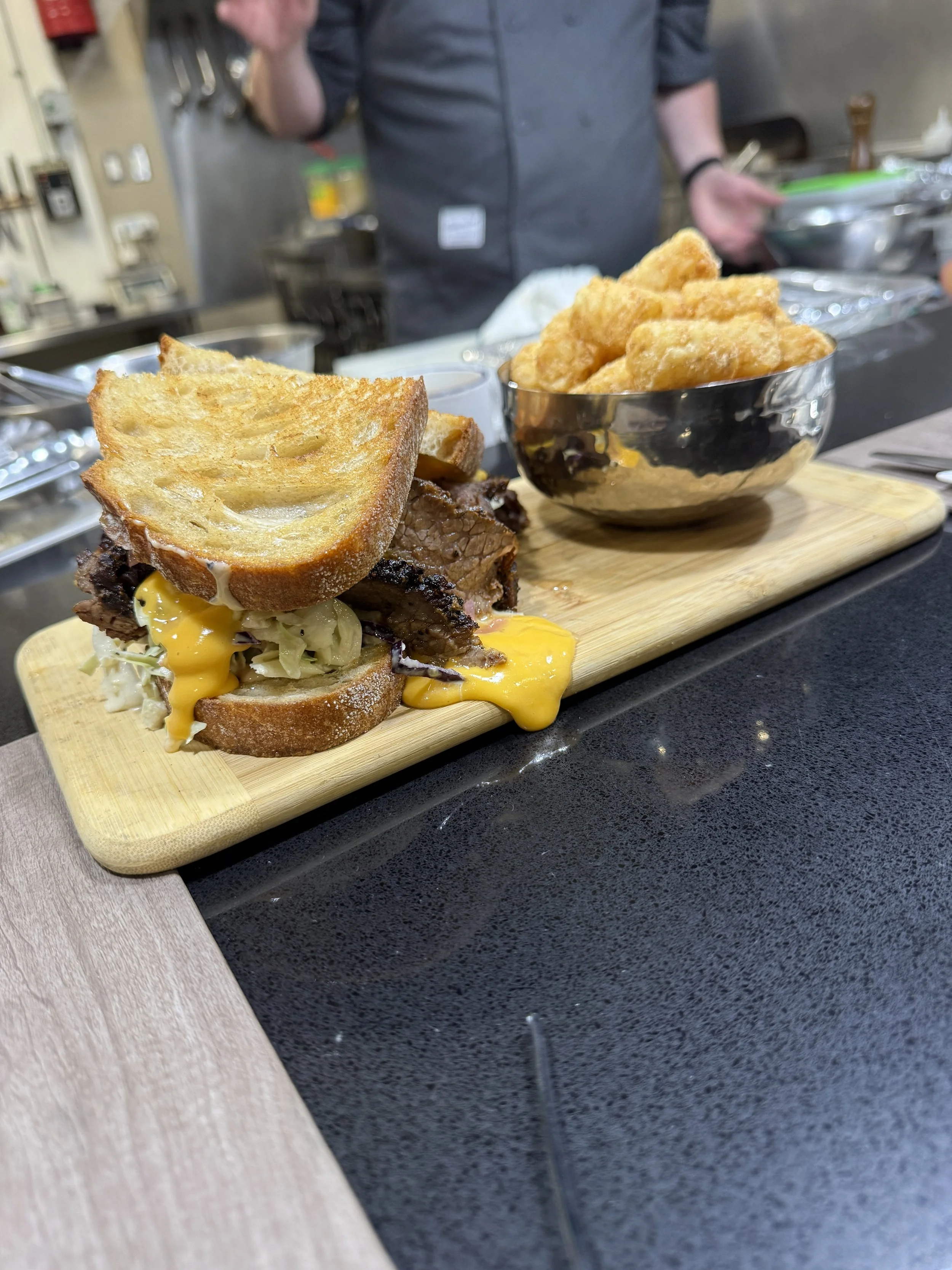smoked brisket on sourdough with beer cheese, pickles, coleslaw
