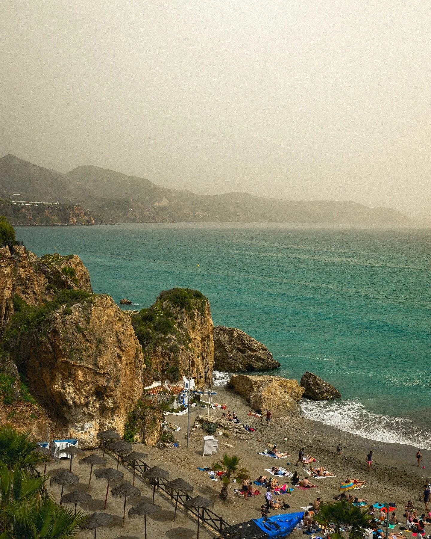 Nerja, Spain 🇪🇸 

The sandy smog look was caused by caused by winds in the Sahara blowing tons of sand overseas onto the southern coast of Spain.

It wasn&rsquo;t as apparent when you were actually there, but these photos (granted, with a bit an ed
