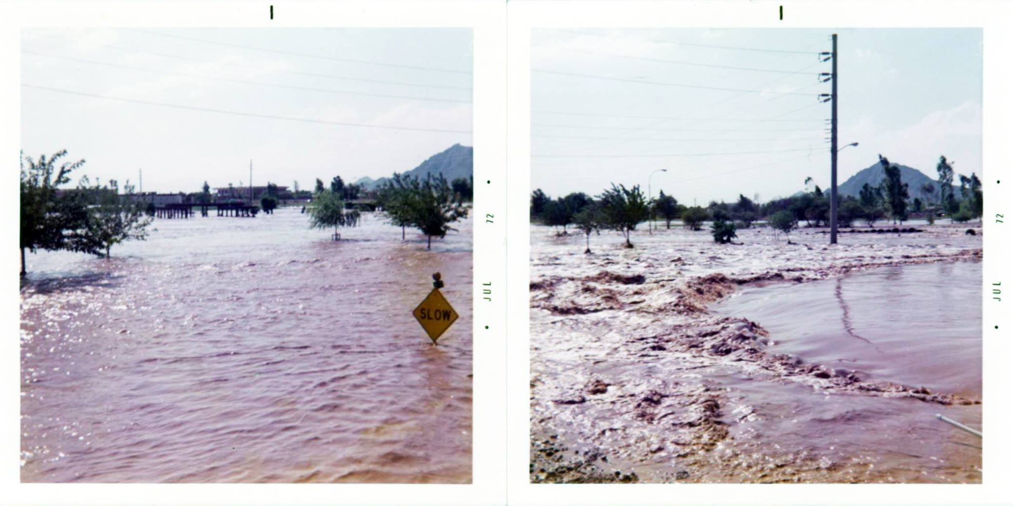 Flooded street in a neighborhood with trees and a caution sign, July 1972.