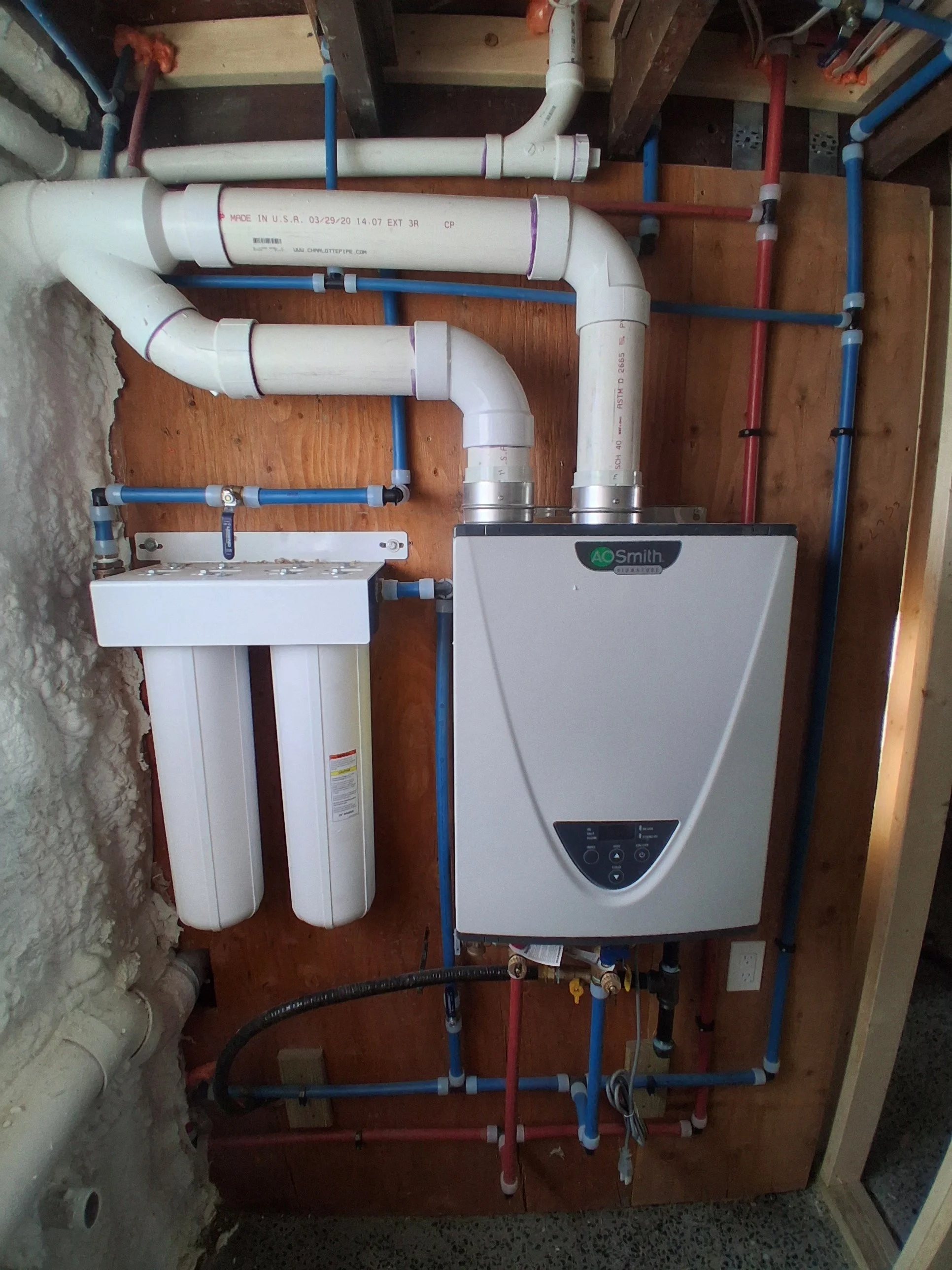 Professional installation of a tankless water heater and a dual-stage water filtration system by RM Electric & Plumbing in the Hudson Valley.