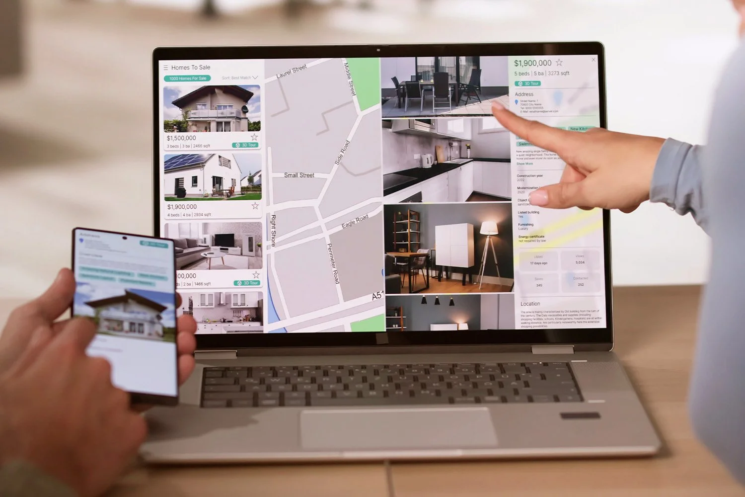People browsing and selecting real estate listings on a laptop and smartphone for homes for sale, showing house images, prices, and a neighborhood map.