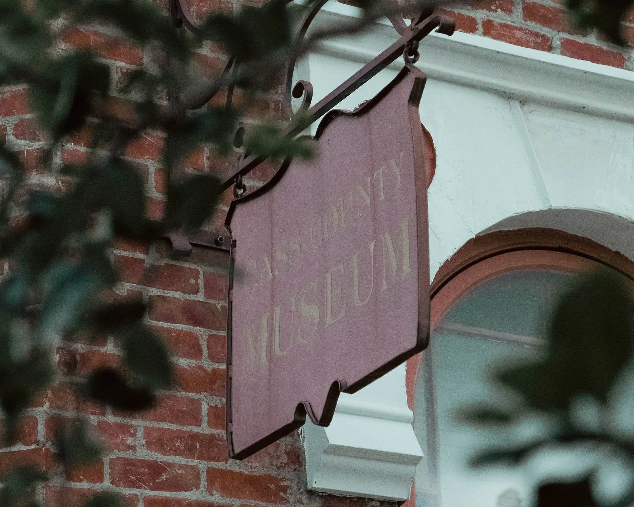 Close-up image of the sign on the front of the museum that reads "Cass County Museum"