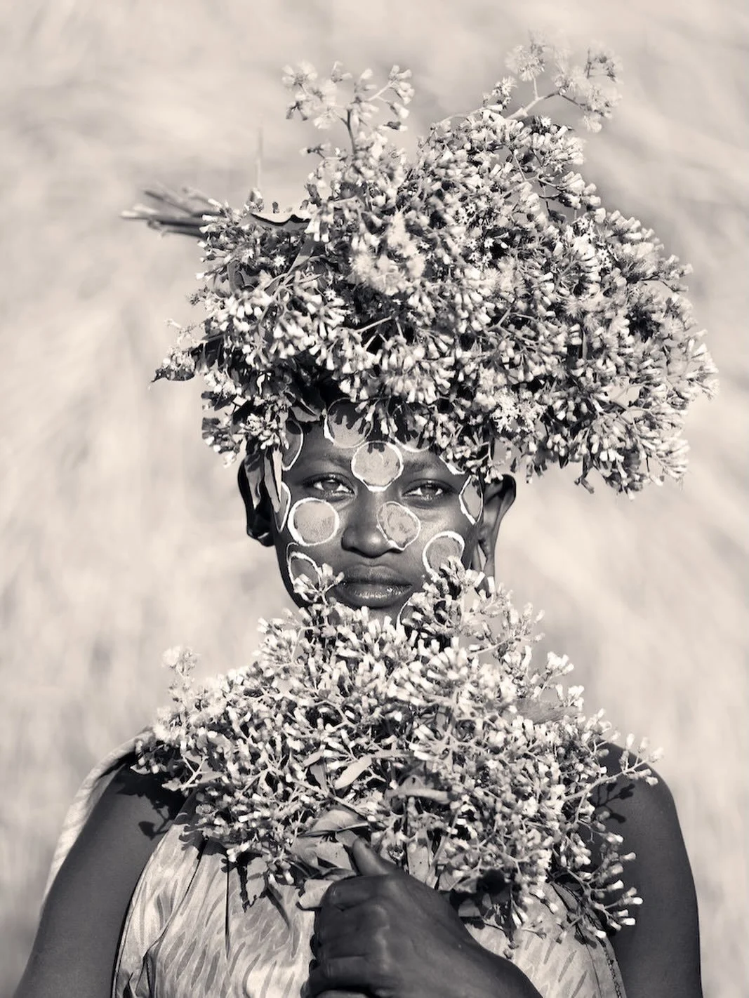 Bloom Keeper by Cristina Mittermeier

Captured in Ethiopia&rsquo;s Omo Valley, Bloom Keeper reflects on beauty as ritual, identity, and cultural continuity. The sitter, a young Suri woman adorned with flowers and traditional body paint, becomes a qui