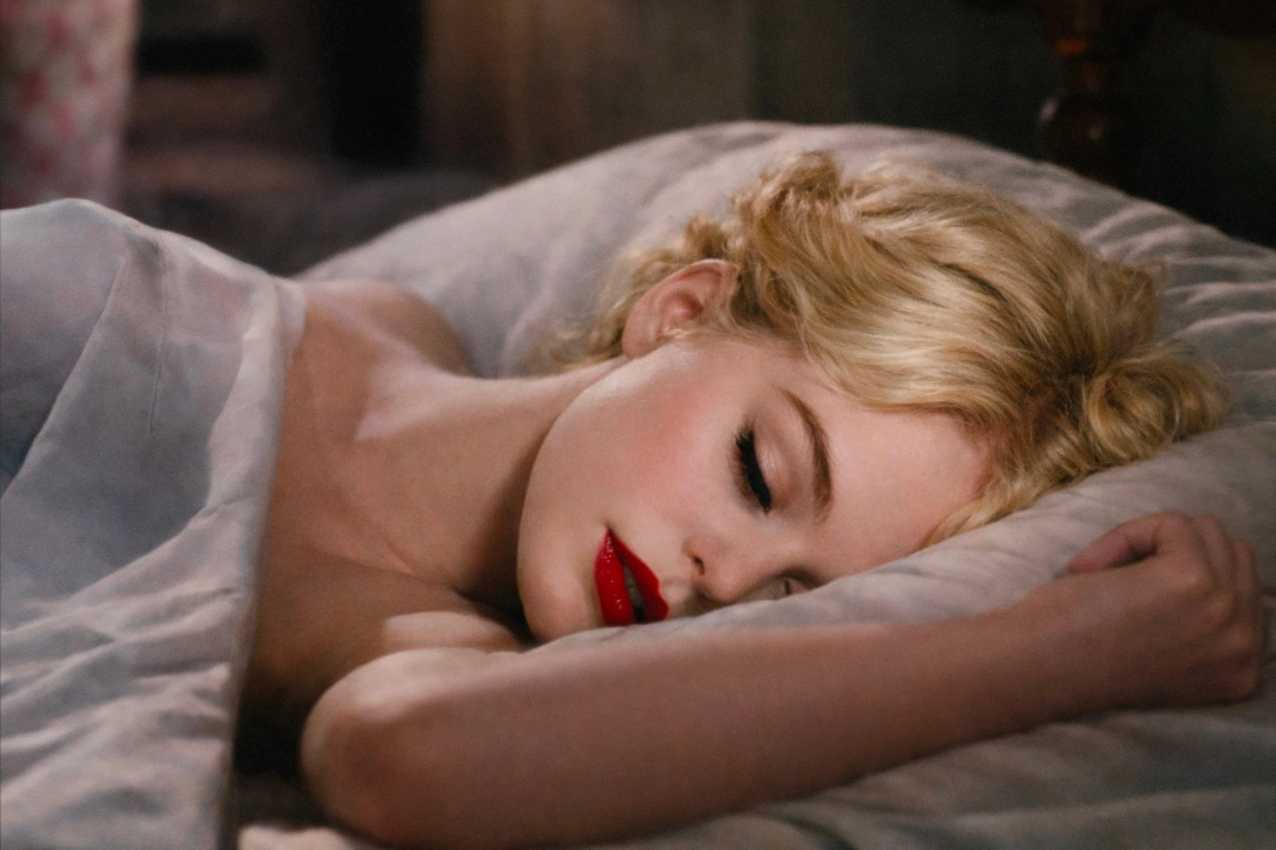 The Sleeping Girl by Tyler Shields inspired by Marilyn Monroe, a girl sleeping in a bed with red lipstick, available at 1905 Contemporary