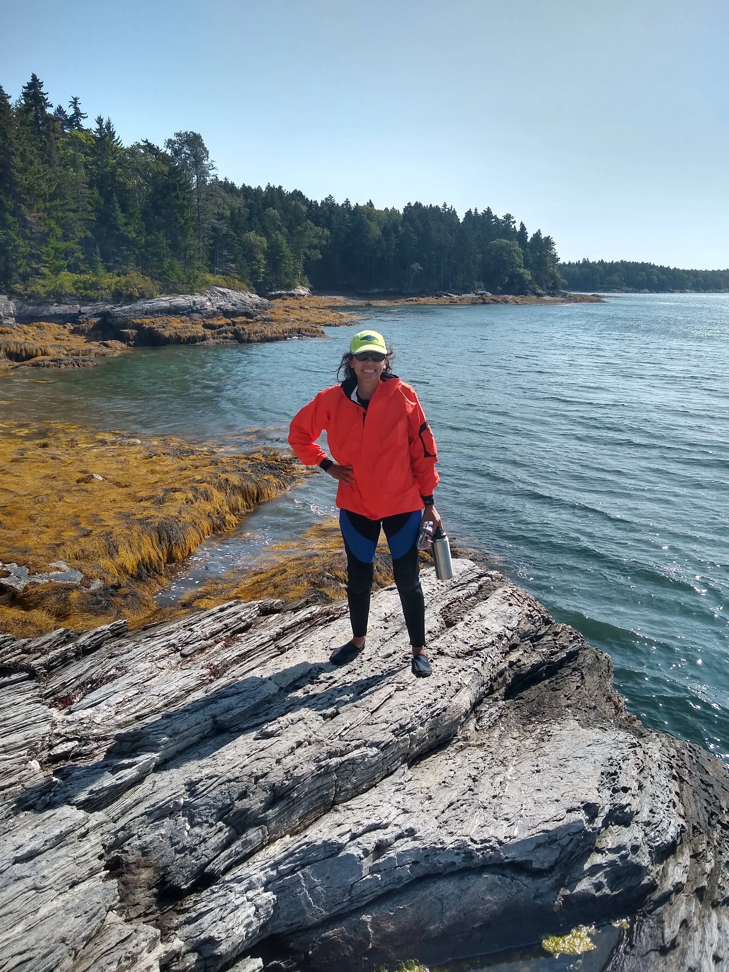 Lauren Manning, MD standing on the rocky coast of Maine