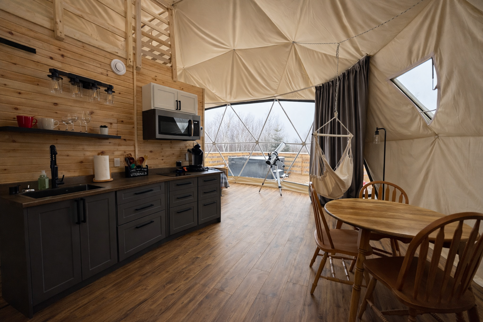 Interior view looking towards large window in luxury glamping dome