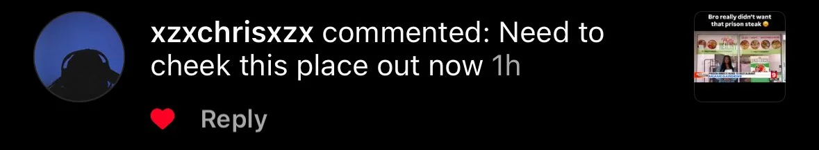 Screenshot of a social media comment about a place, with a small thumbnail of a video or image in the corner showing a person and a display of food items or dishes.