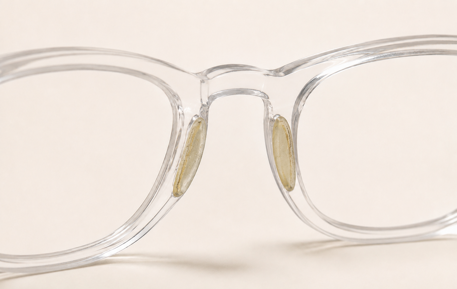 Close-up of a pair of eyeglasses with anti-slip nose pads that has discolored