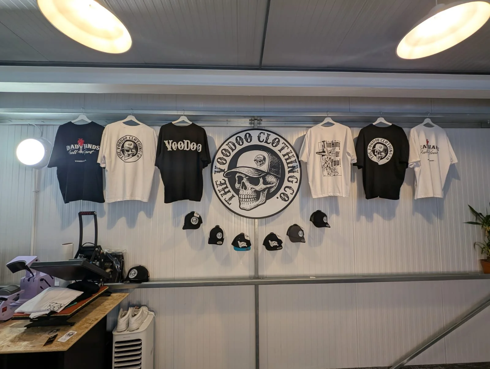 A selection of black and white t-shirts with VooDoo Clothing designs