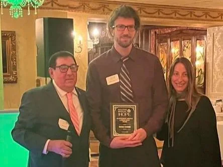 Matthew with his Building Bridges With Hope Outstanding Service and Dedication Award
