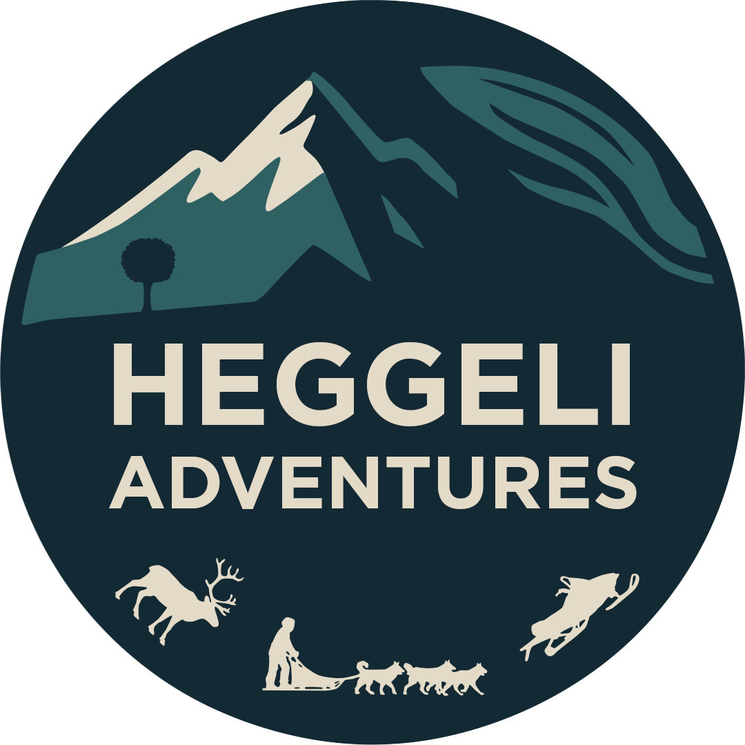 Logo for Heggeli Adventures featuring mountains, trees, a person with dogs, a reindeer, and a mountain goat.
