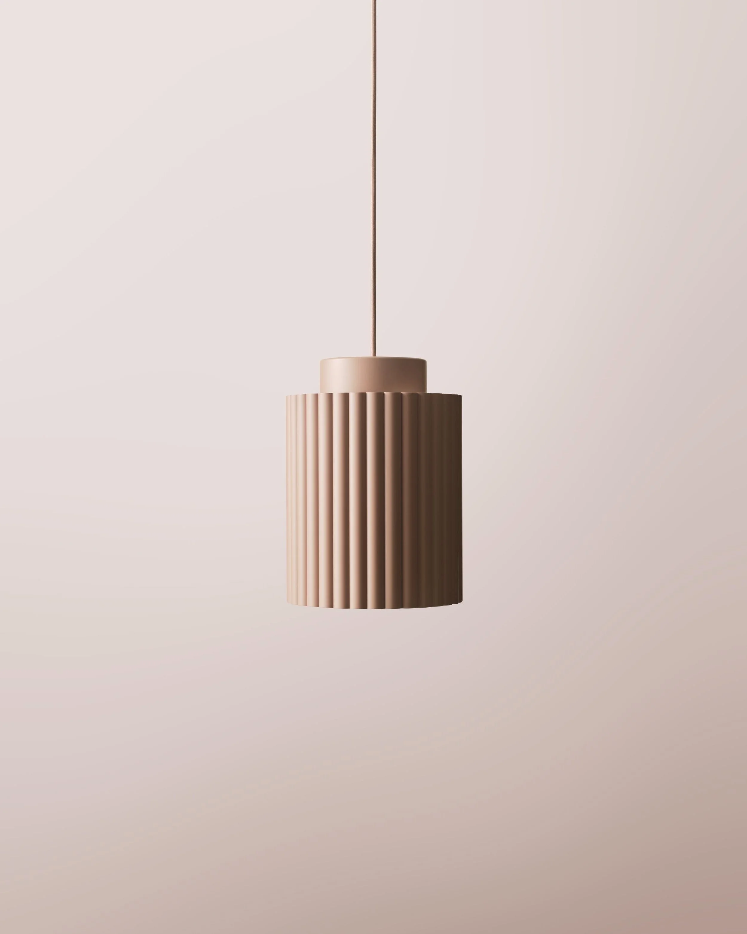 A beige, modern pendant light with vertical ridges hanging from a ceiling against a plain background.