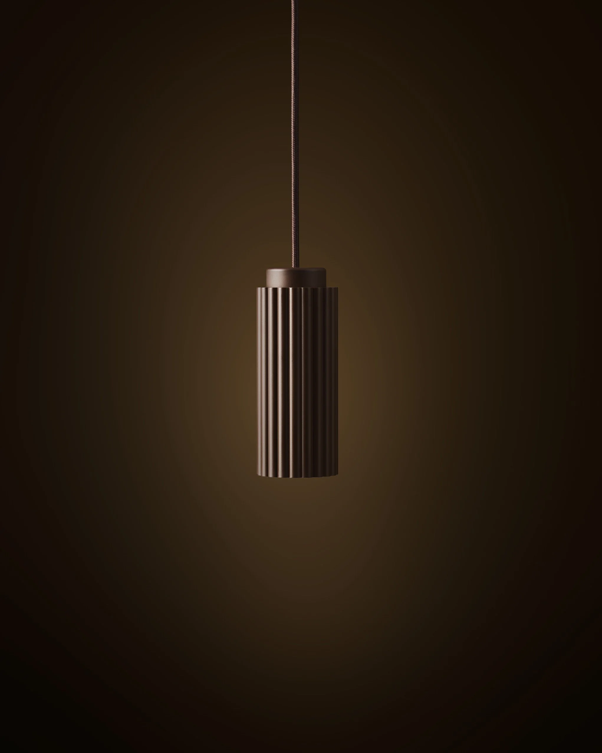 A modern brown pendant light hanging from a cord against a dark background.