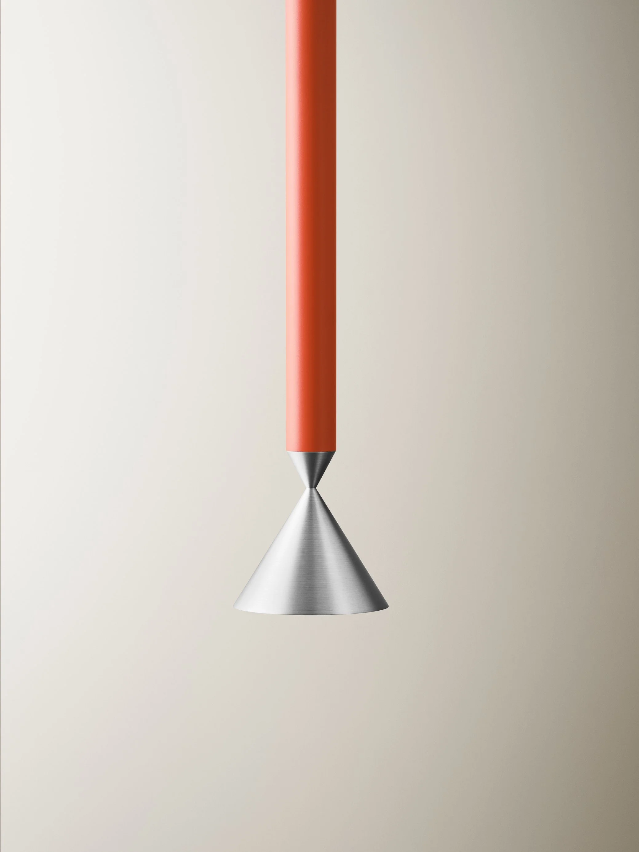 A modern mathematical or artistic device with an orange handle and a metallic conical shape hanging from the tip.