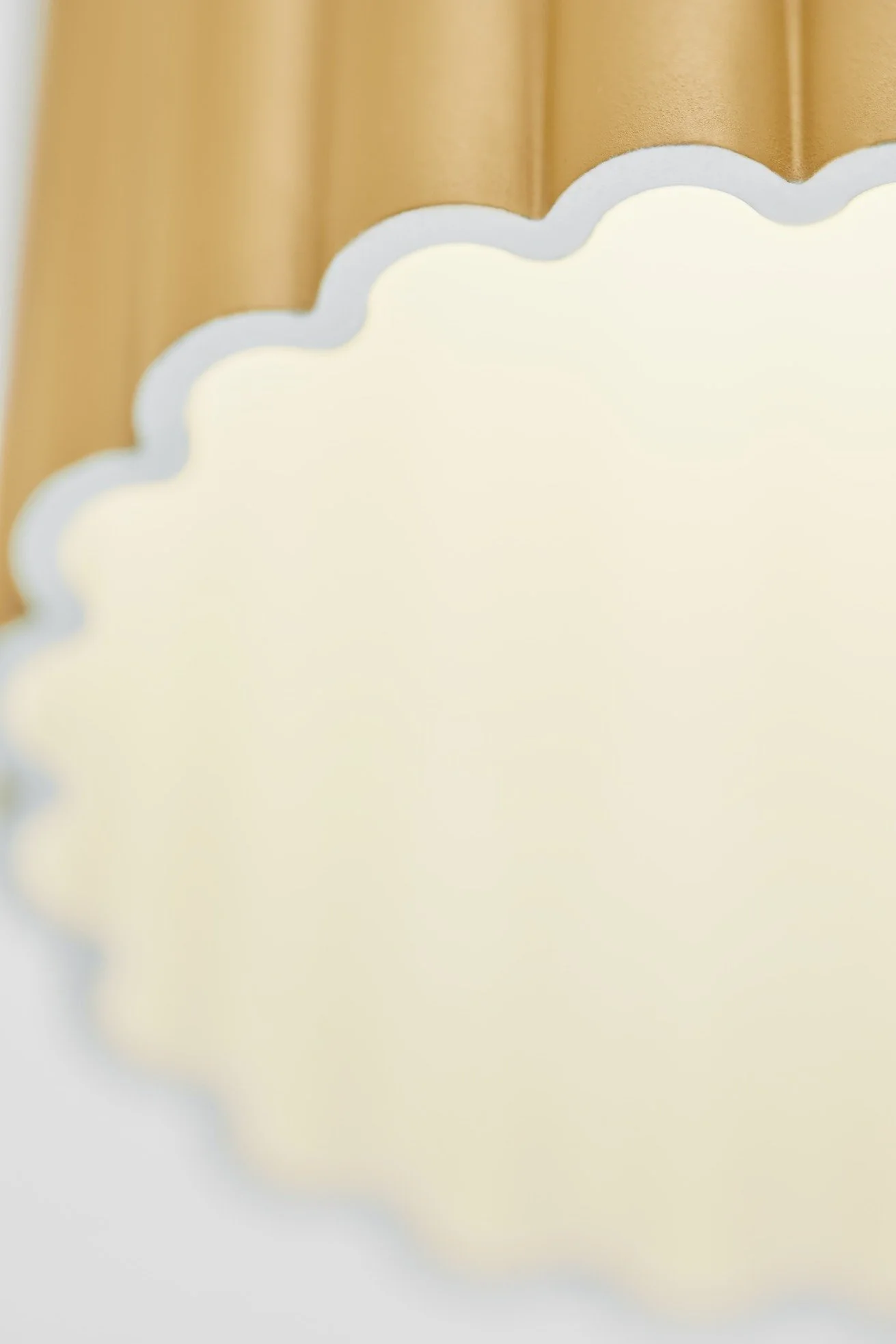 Close-up of a cloud-shaped light fixture or decoration with a wooden background.