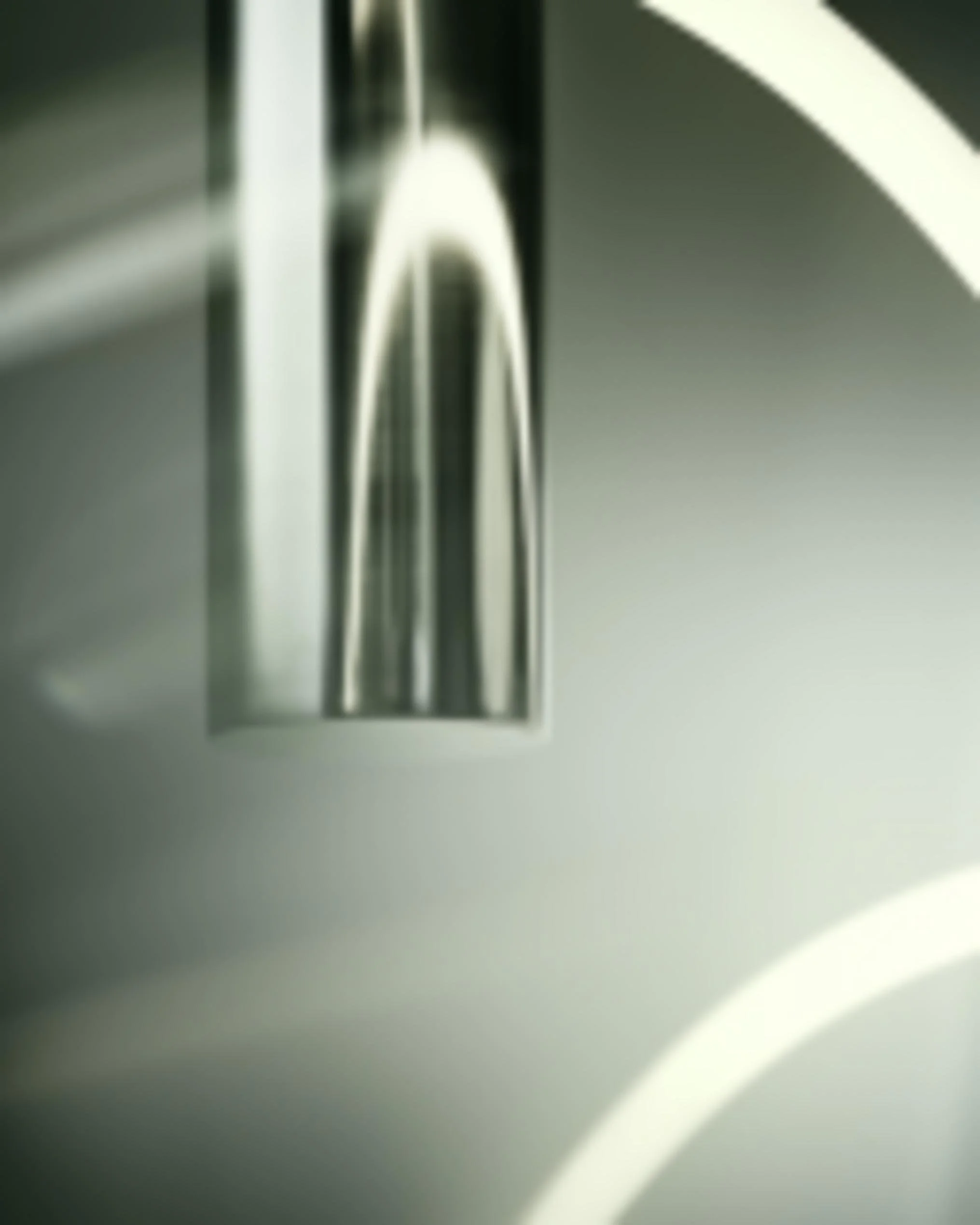 Close-up of a modern faucet attached to a white sink.