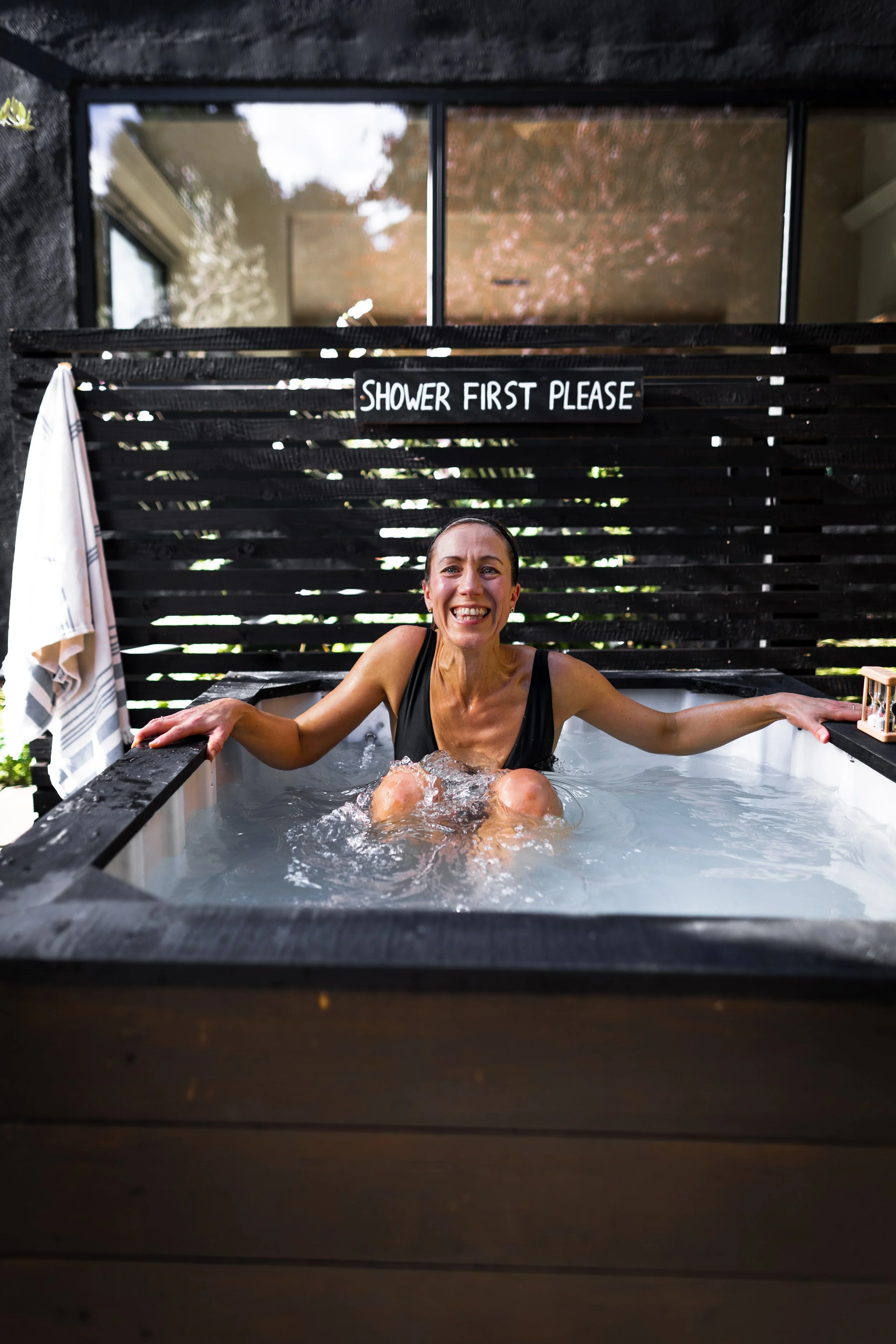 Smiling woman in ice bath