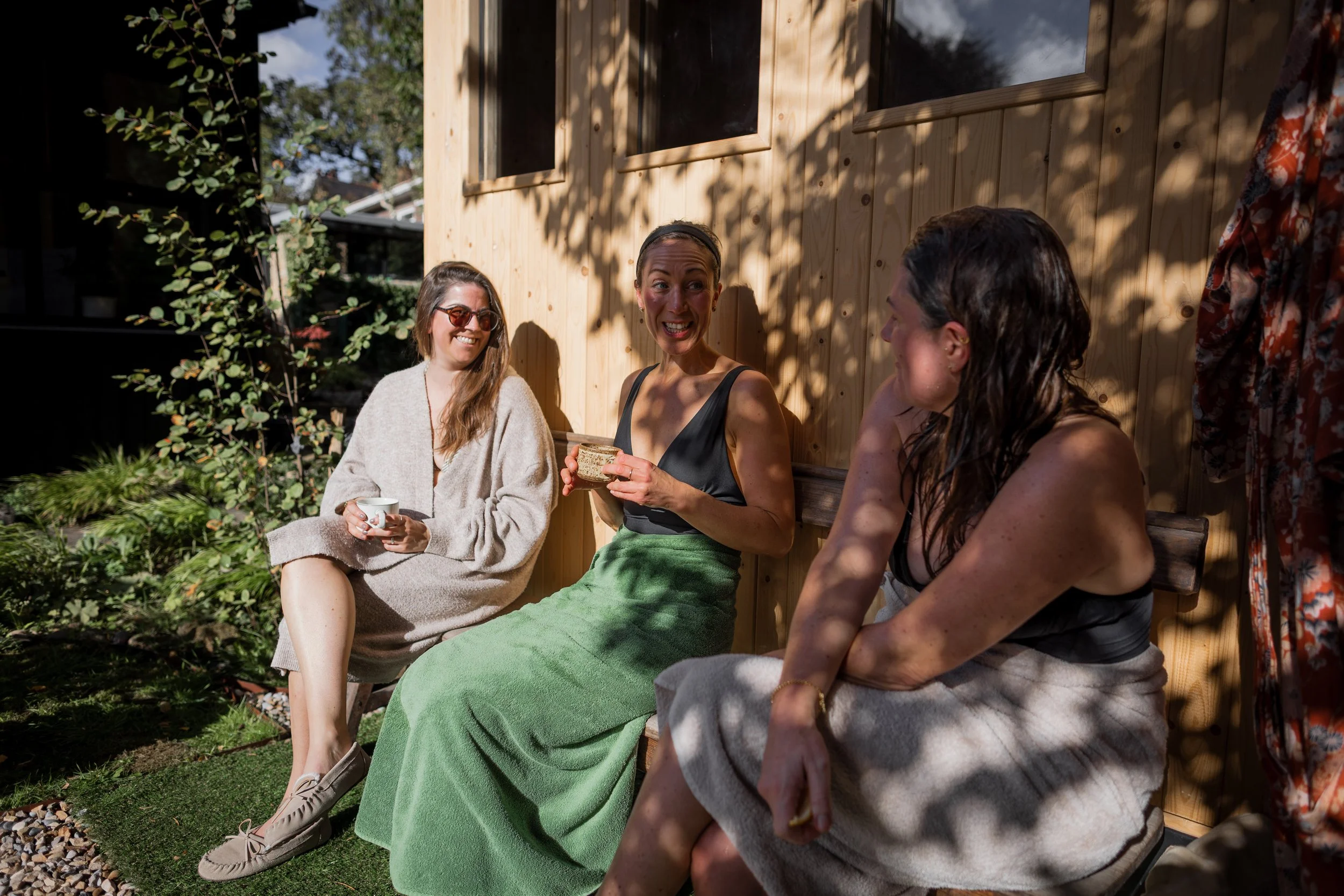 3 friends chatting outside sauna