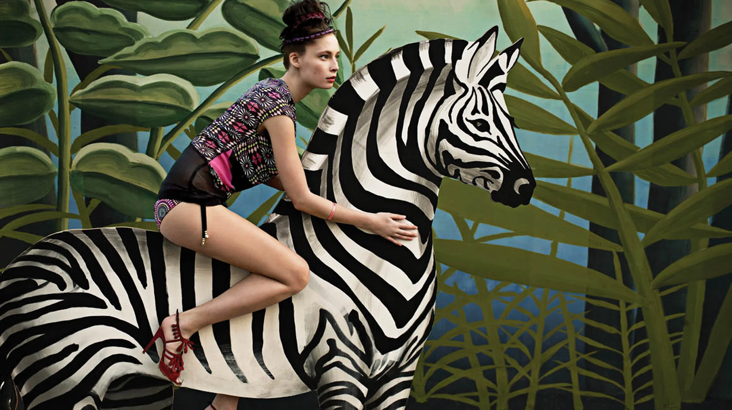 Vibrant patterns inspired by painter Henri Rousseau, jungle-themed. whimsical and bohemian aesthetic, with models posing against lush, theatrical backdrops featuring a painted cutout zebra..