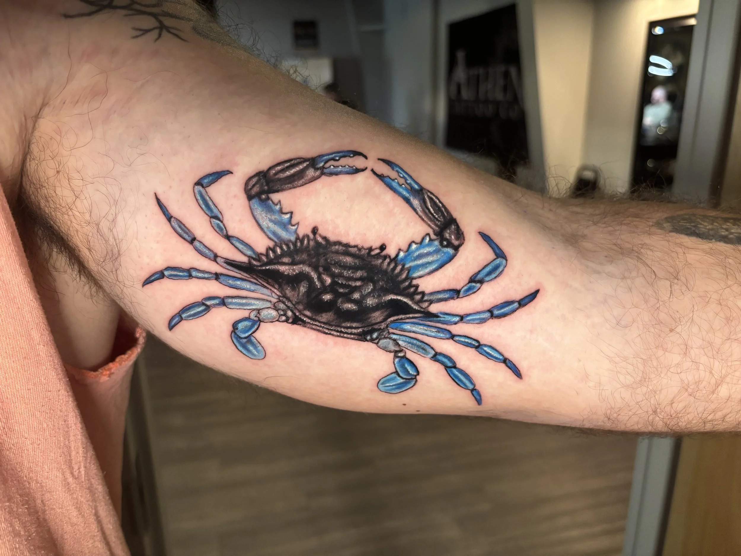 Black and grey blue crab bicep tattoo