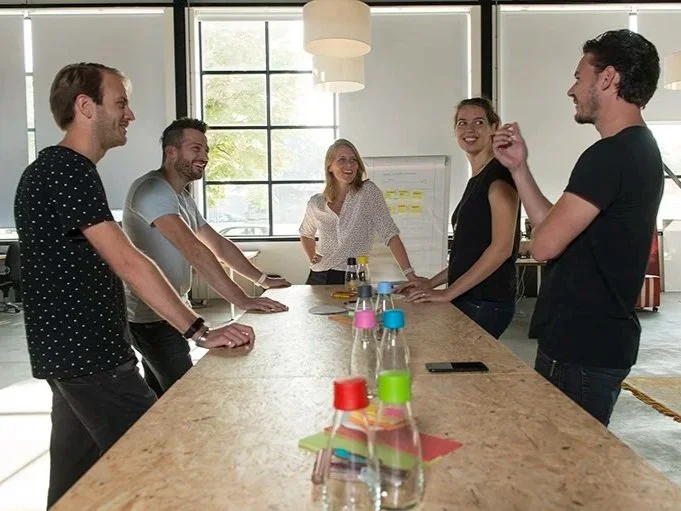 Leaders collaborating around a table during a leadership development workshop