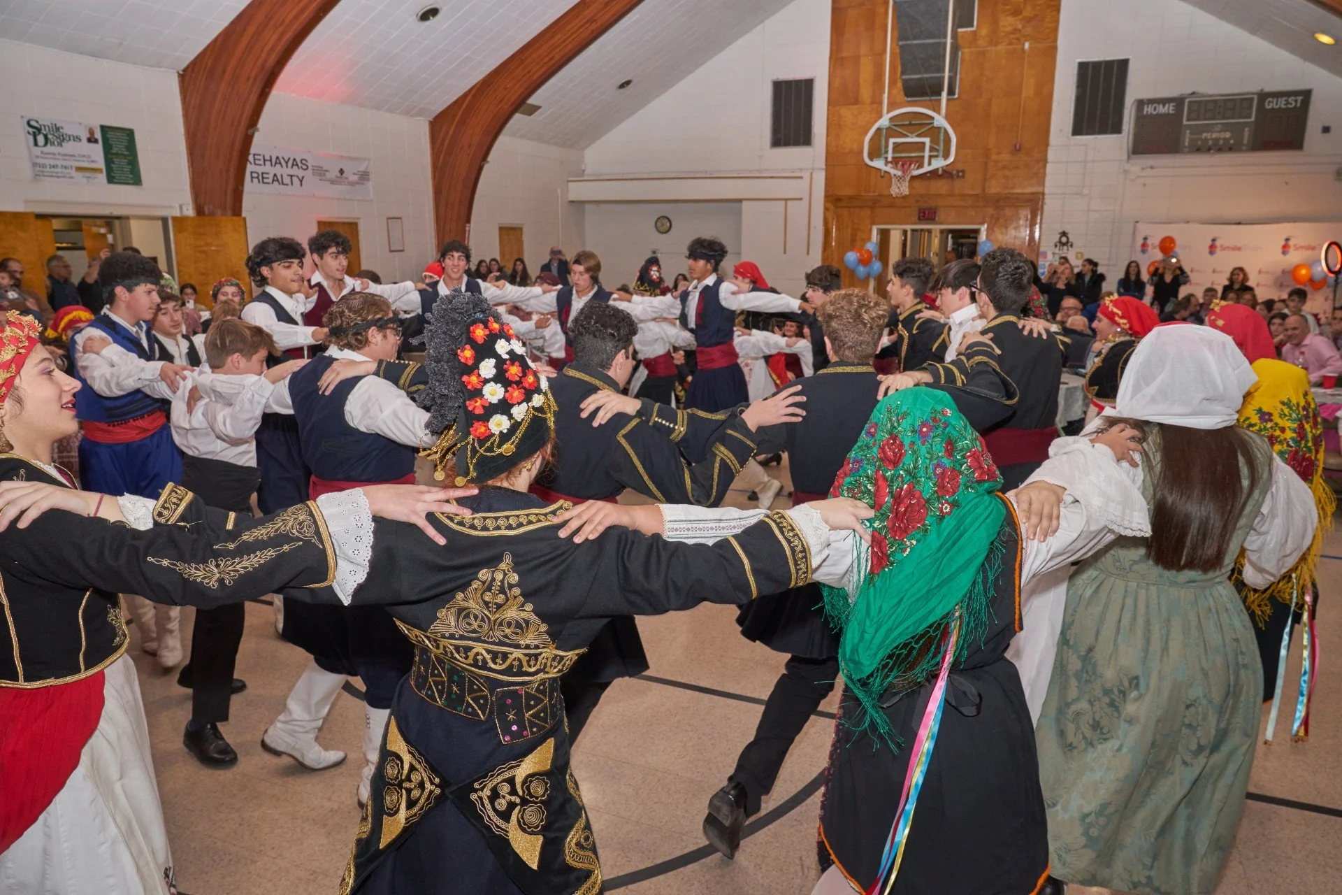 A group of people dancing a traditional Greek dance.