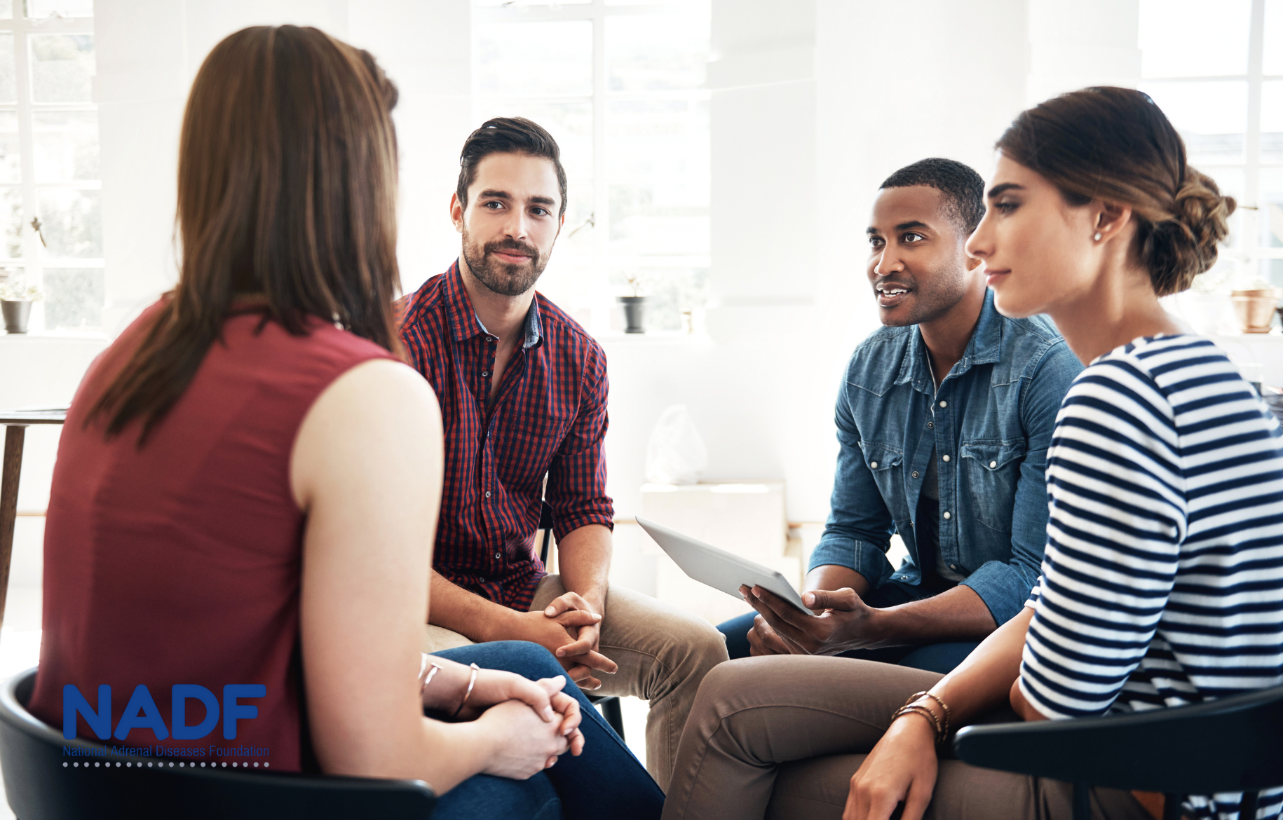 Four people having a conversation.