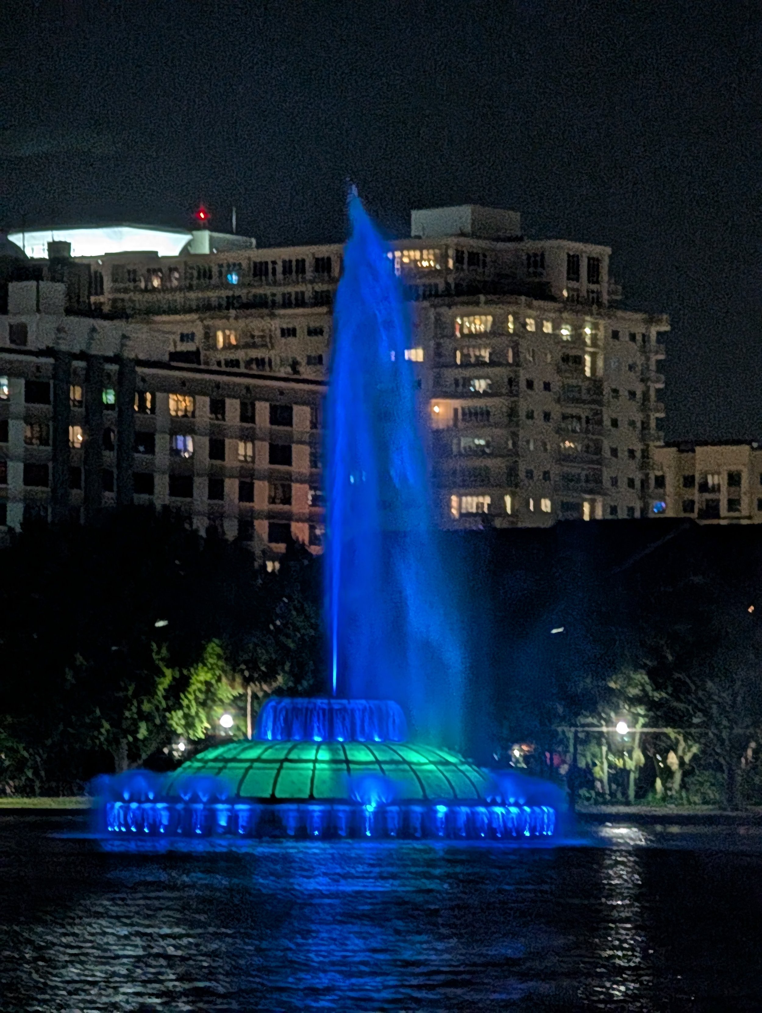 A fountain lit up in blue lights.