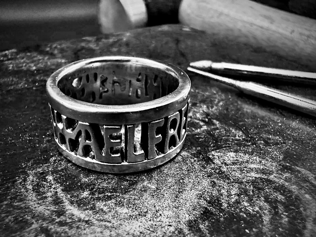 The Alfred Ring, inspired by the kingdom of Wessex, on a rubber jeweller's forming block with a Thor hammer in the background