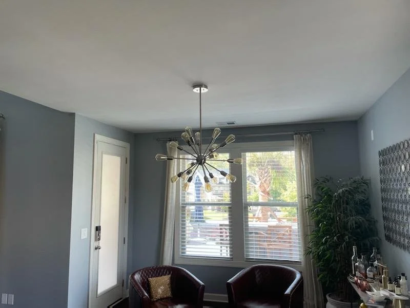 Multi-arm chandelier installed by Loftis Lighting & Electrical in a finished sitting room