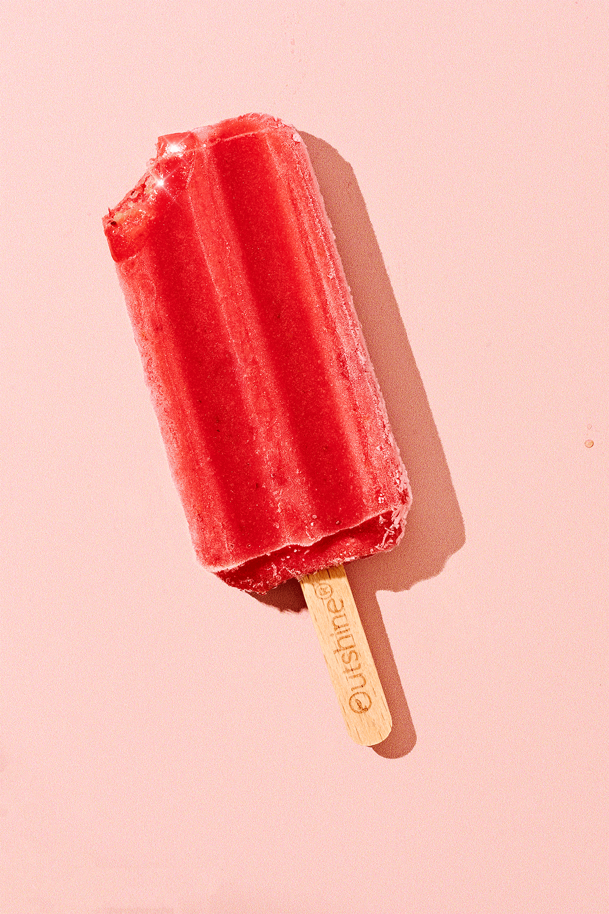 Red popsicle on a light pink background with shadow commercial food photography product photographer freelance consumer brand stop motion animation video