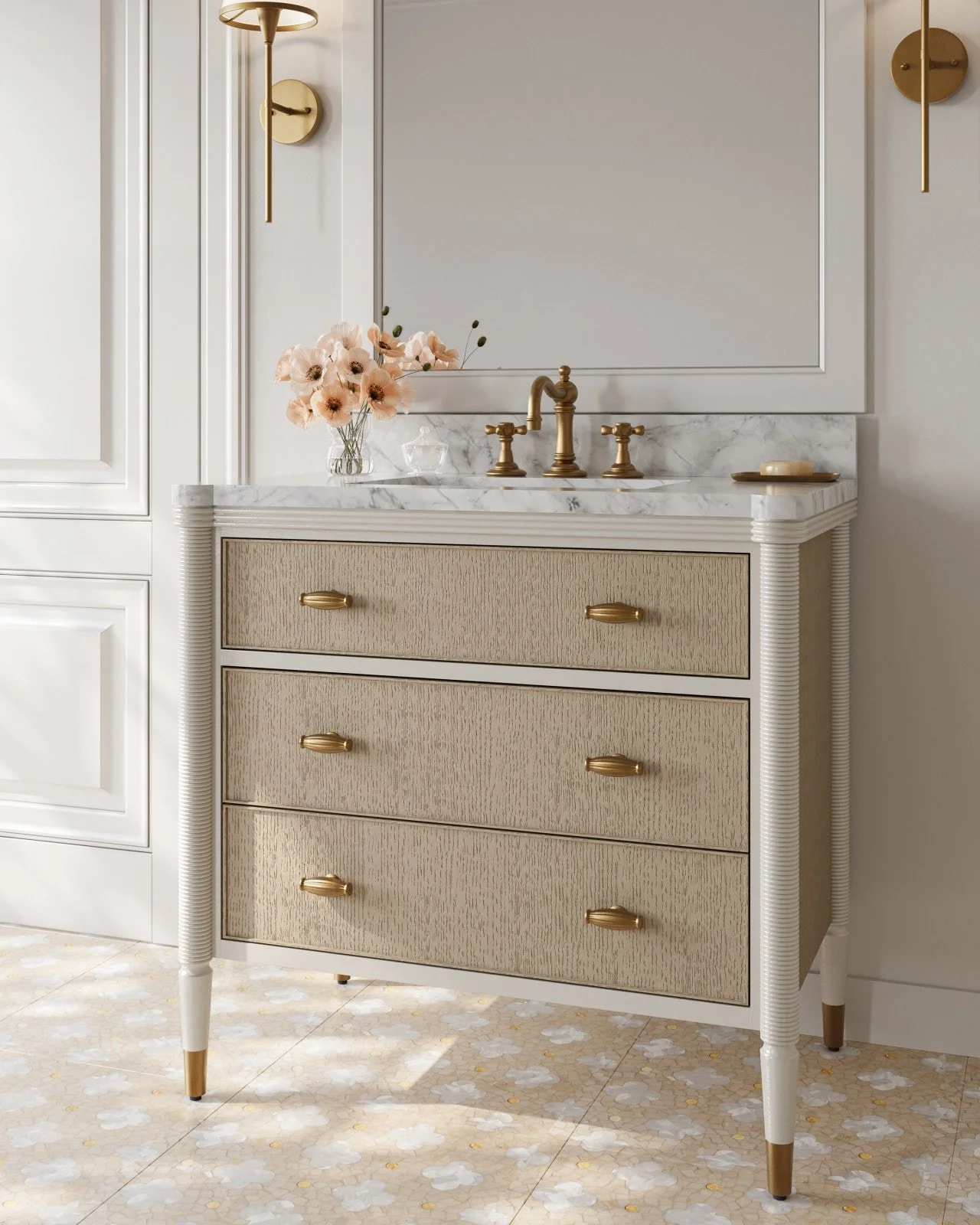 A vintage style bathroom vanity with a marble top and gold hardware, featuring a mirror behind and a vase with pink flowers on top.