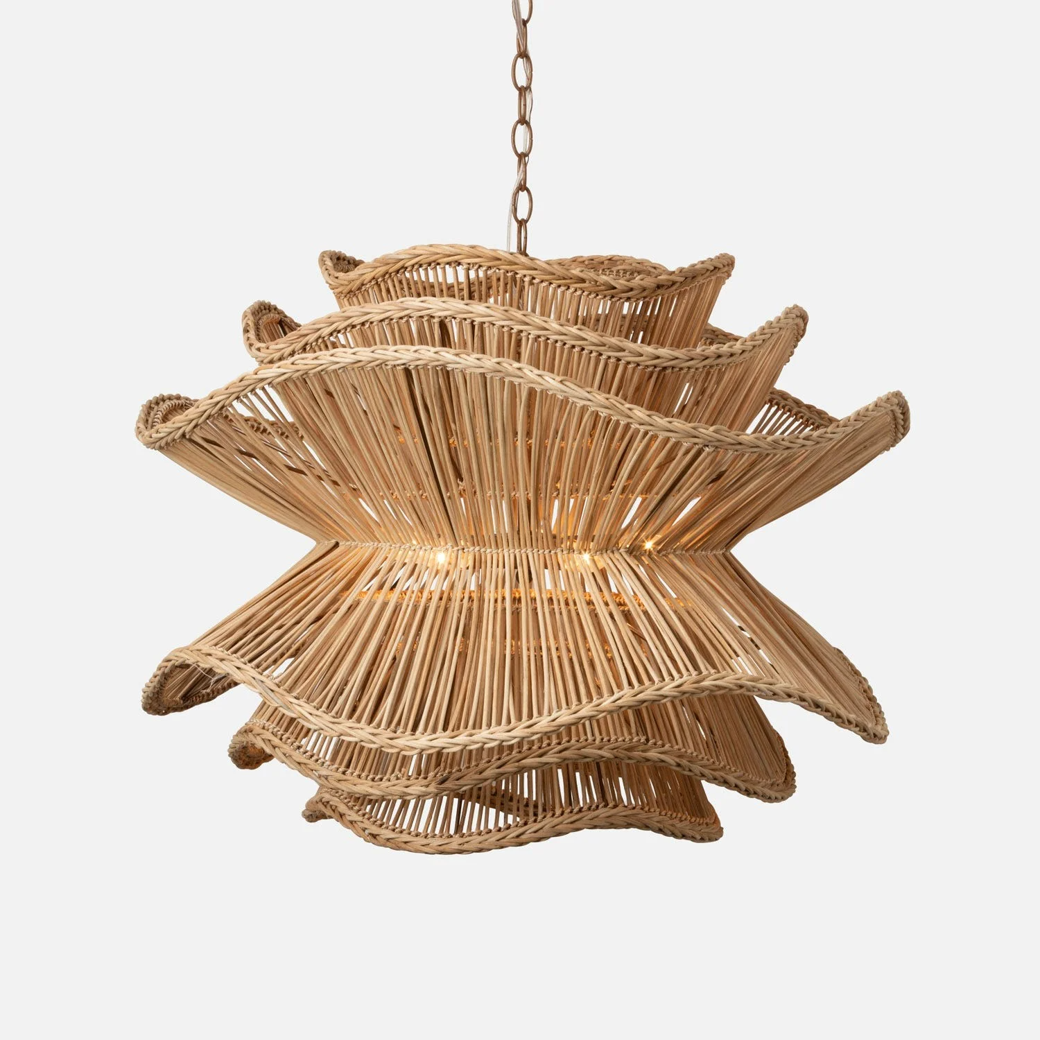 Woven rattan pendant light with multiple layers and an illuminated light bulb inside.