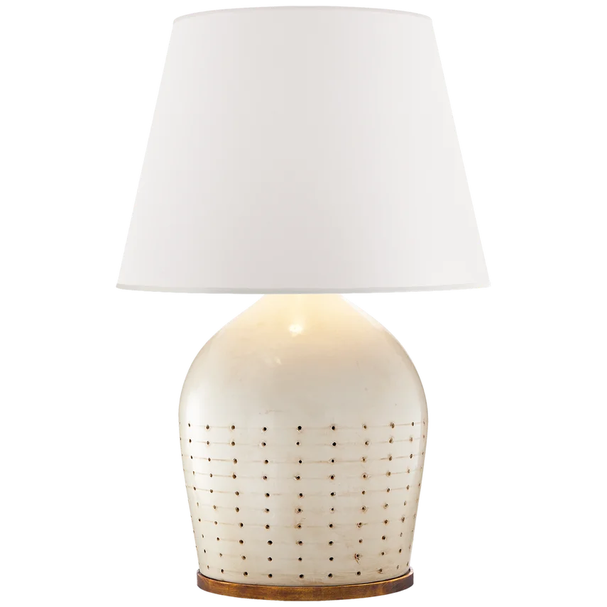 A table lamp with a white, textured ceramic base and a white with slight beige tone lampshade.