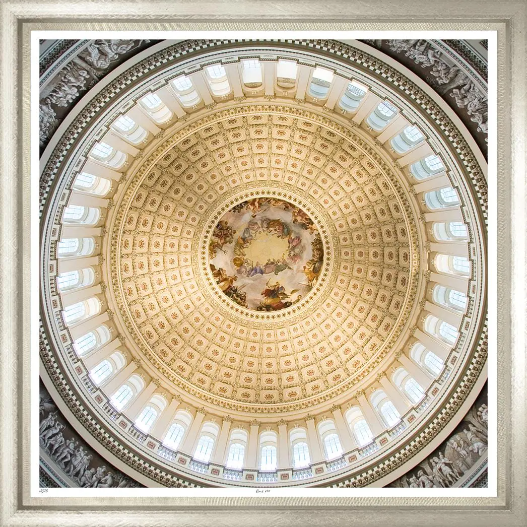 View of a domed ceiling with intricate gold detailing, windows around the perimeter, and a central painted fresco depicting mythological or historical figures.