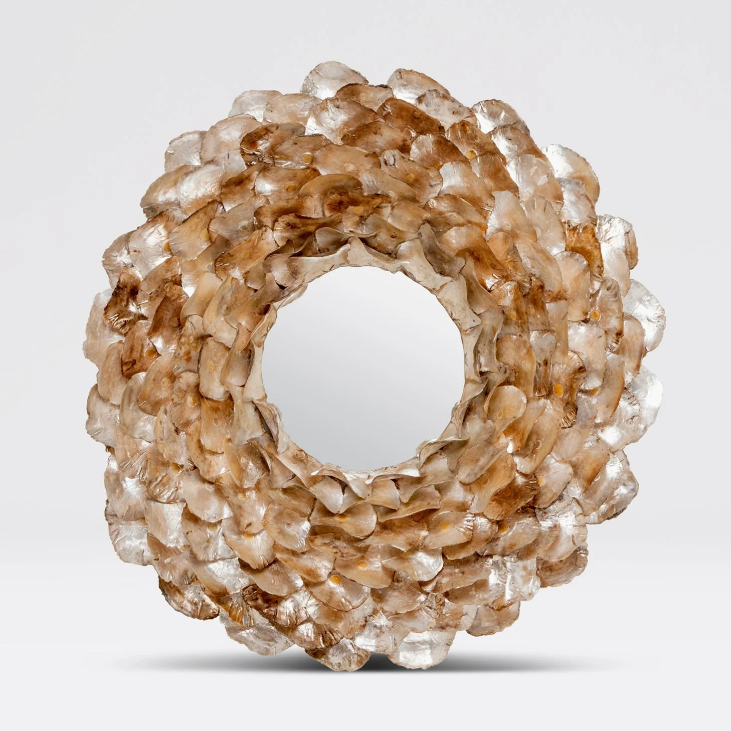 Decorative wreath made of oyster shells with a circular shape and textured surface.