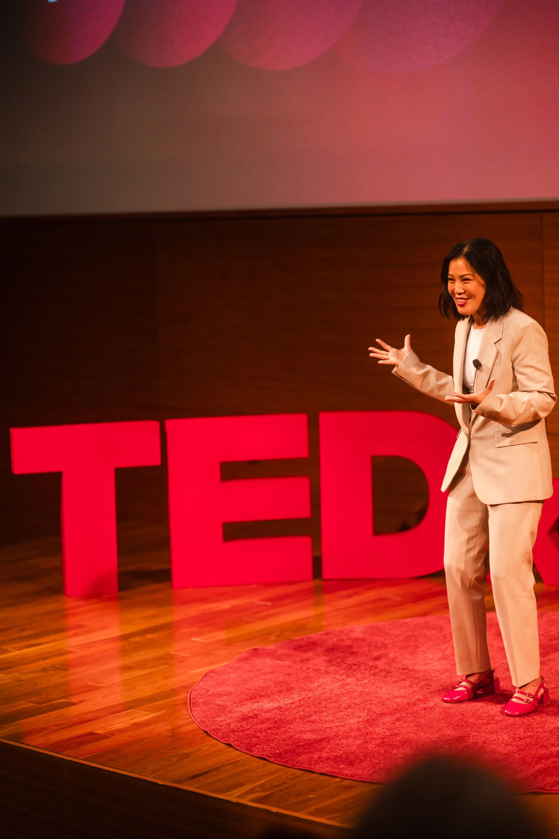 A speaker on the TEDxUnityPark stage