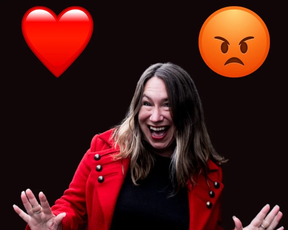Woman in red coat smiling with heart and angry face emojis on dark background.