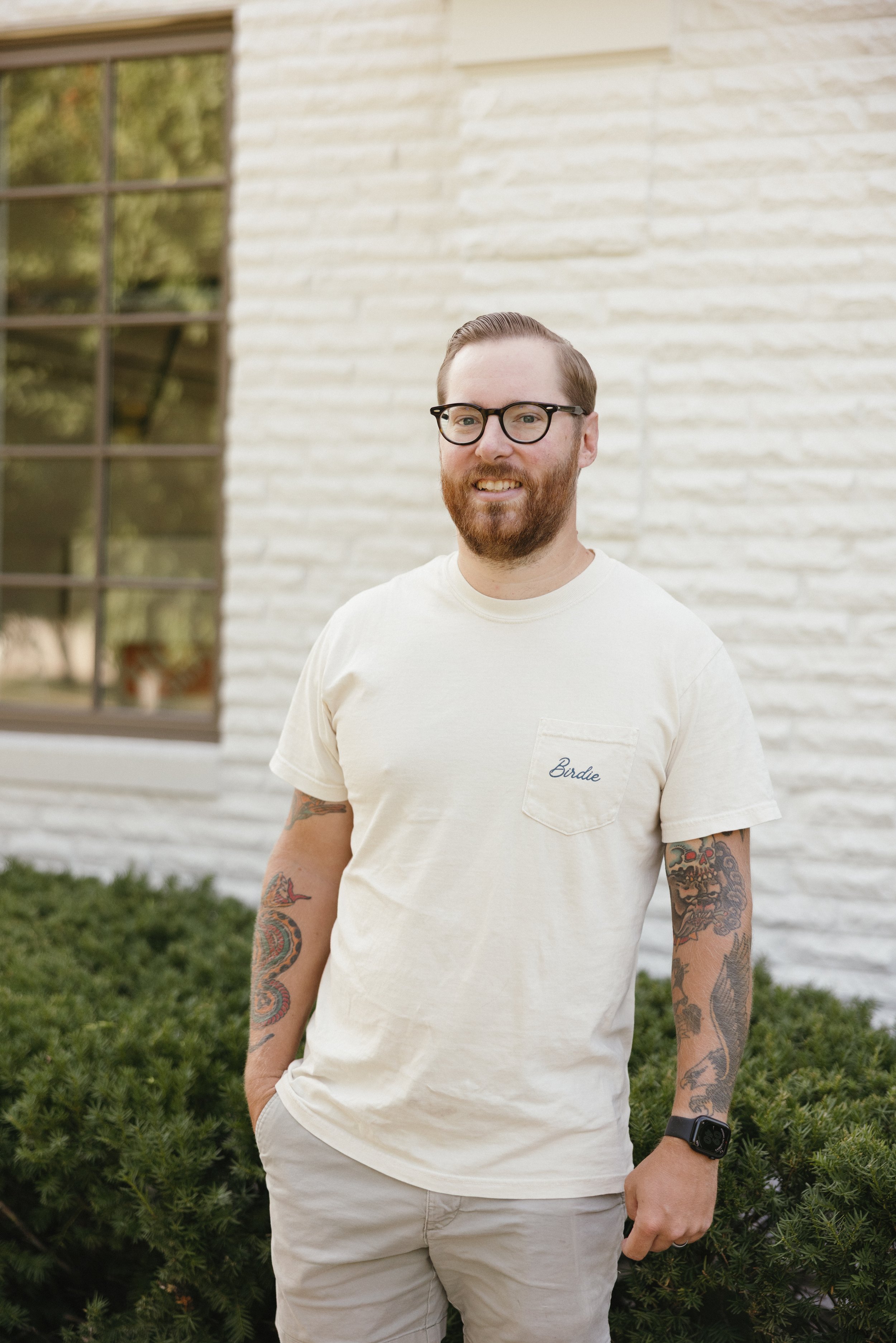 Paul, owner of Birdie Window Cleaning, standing next to a completed home in Clive, IA