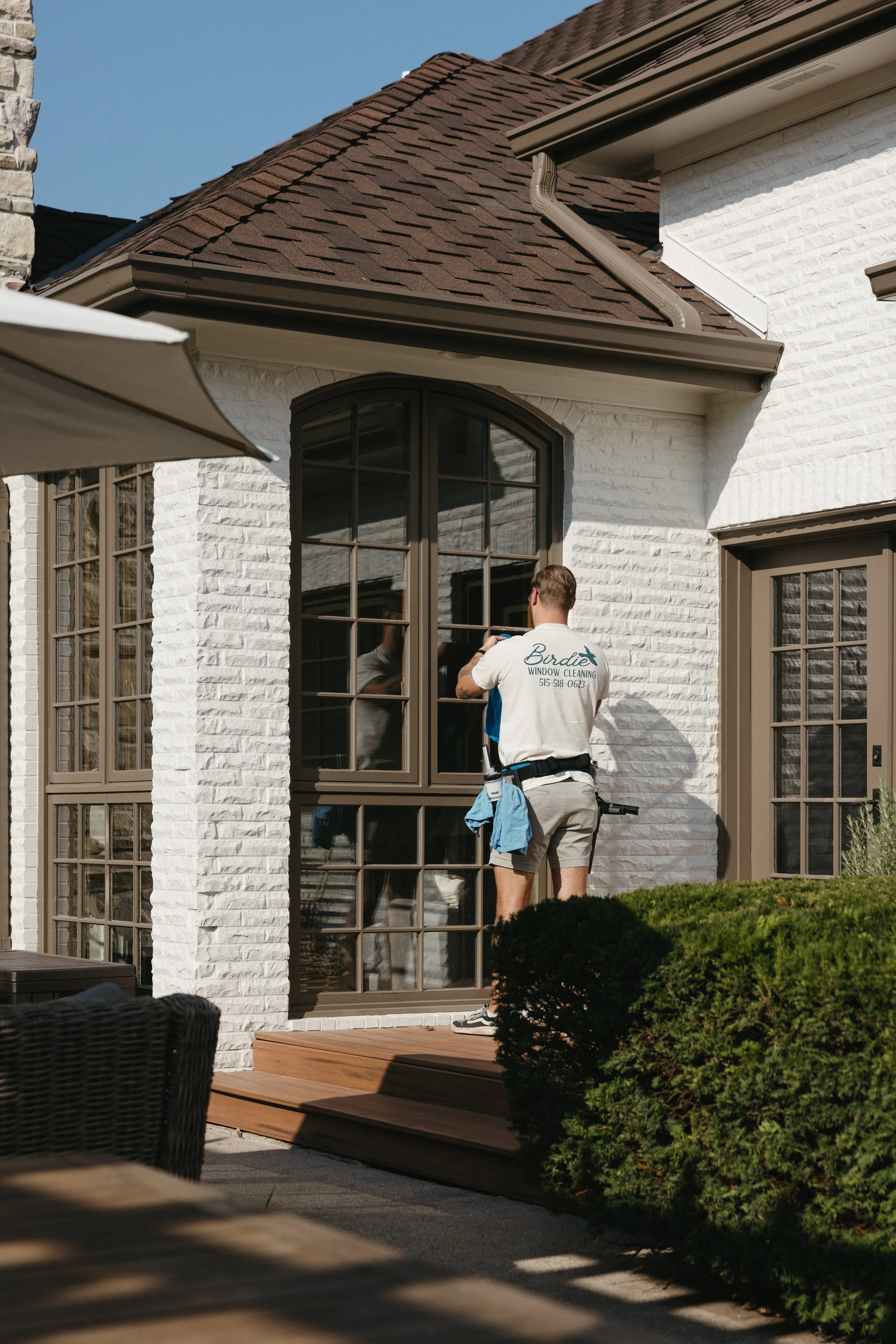 Birdie Window Cleaning specialist completing exterior window cleaning service in Johnston, IA with expert care and attention. Exterior Window Cleaning Service Near Me.