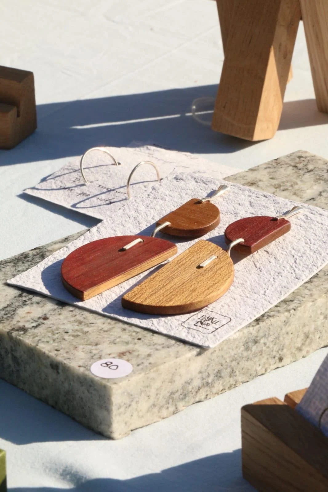 Un bâtiment à colombages avec des poutres en bois foncé et des murs clairs, doté de fenêtres à cadre rouge.