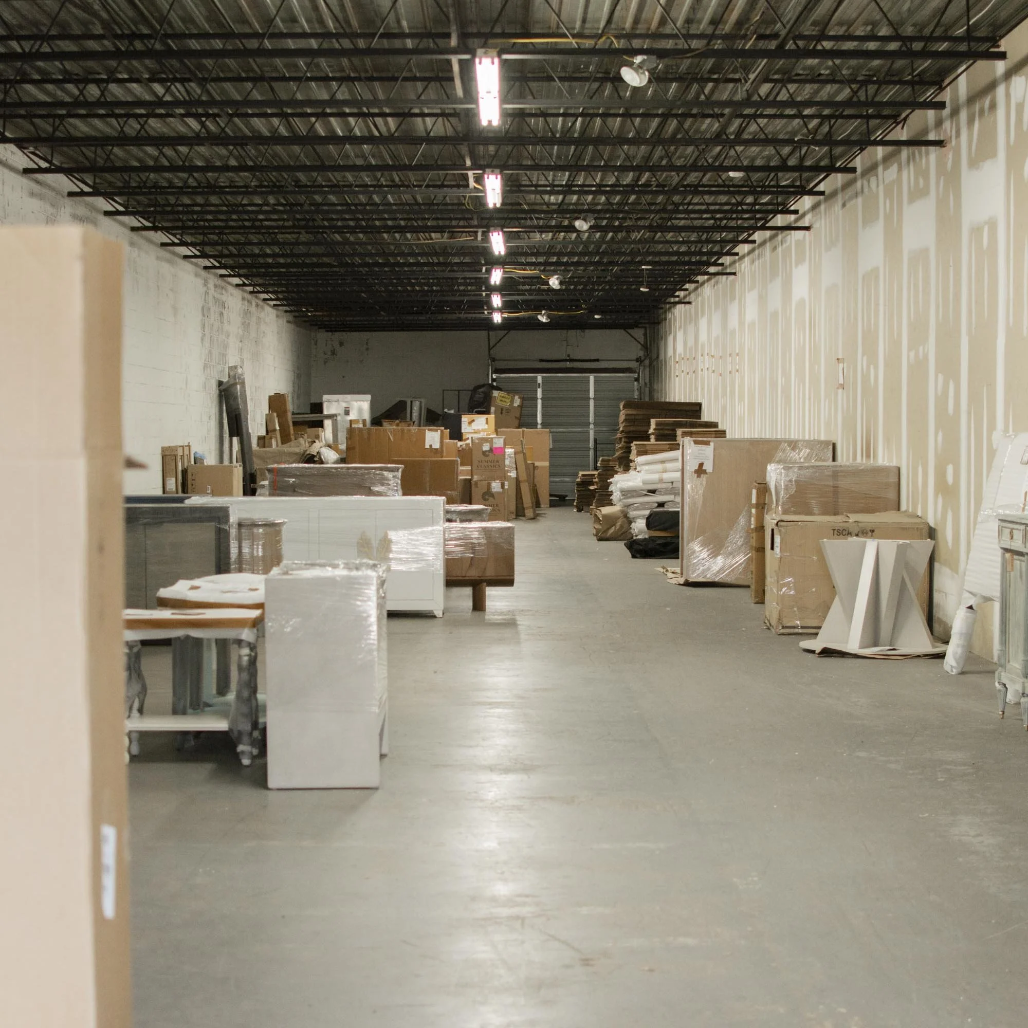 Warehouse interior with stacked boxes and pallets.