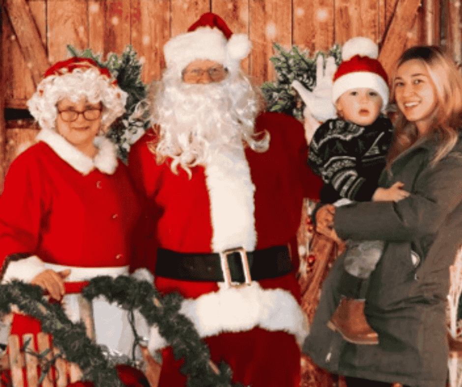 Santa posing with kids for Holiday in the Highlands